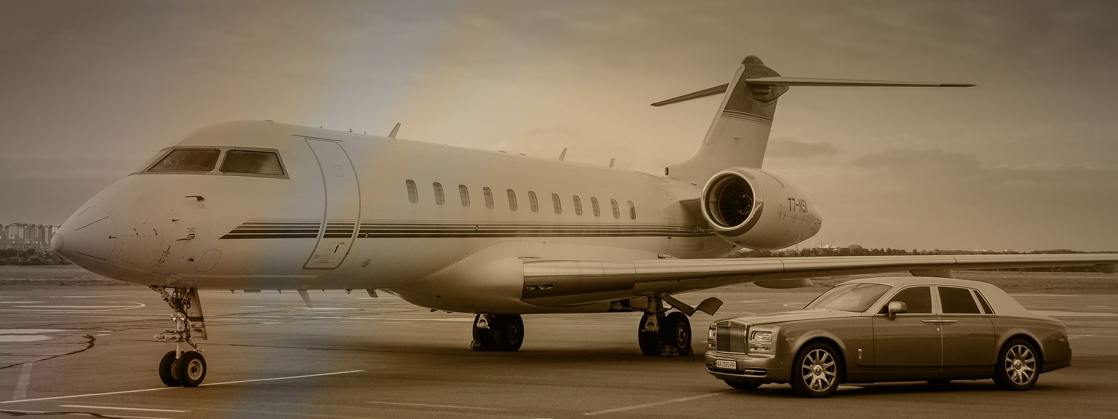 Private jet and luxury car on runway.