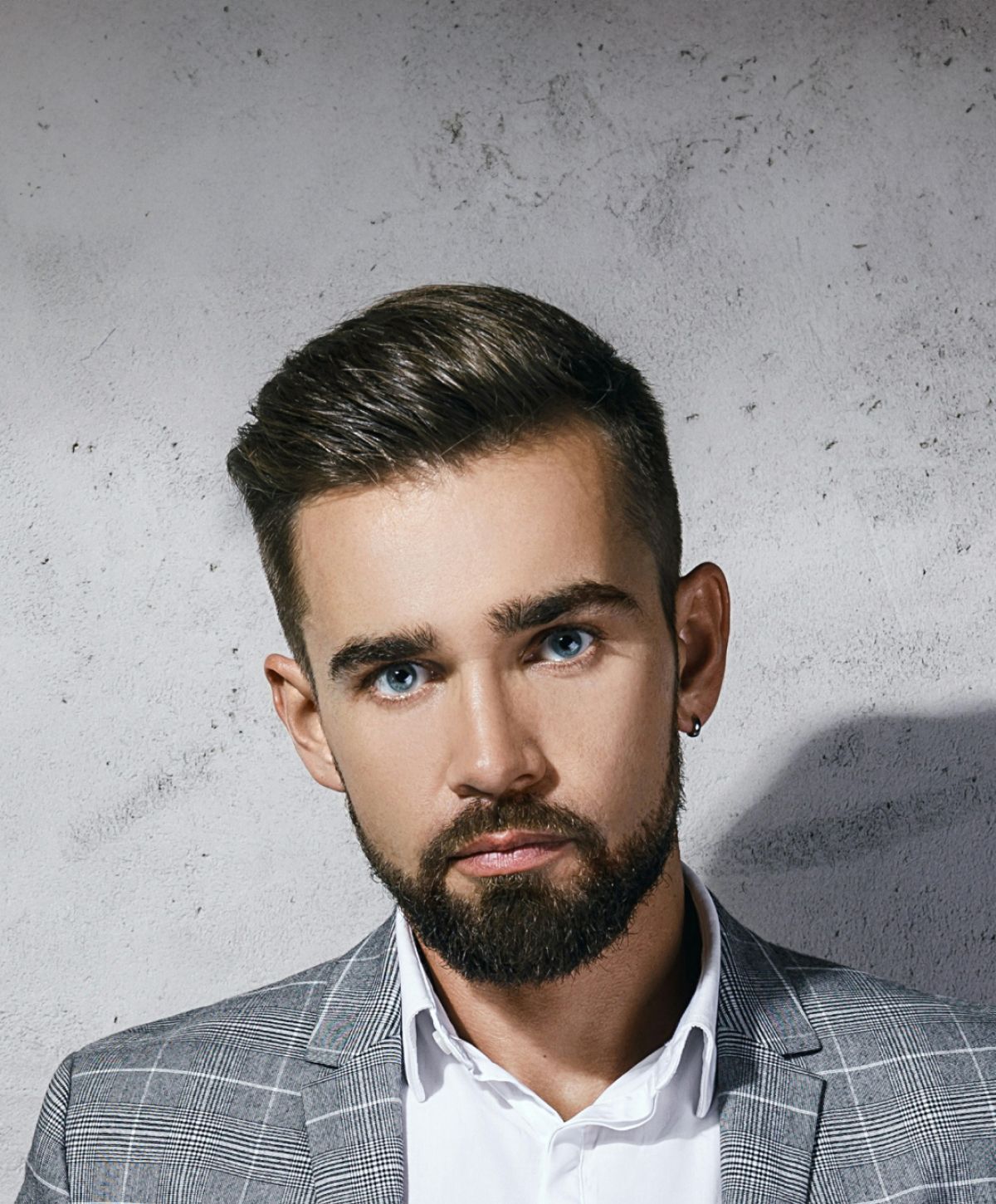 Avon hair restoration model with beard in stylish suit.