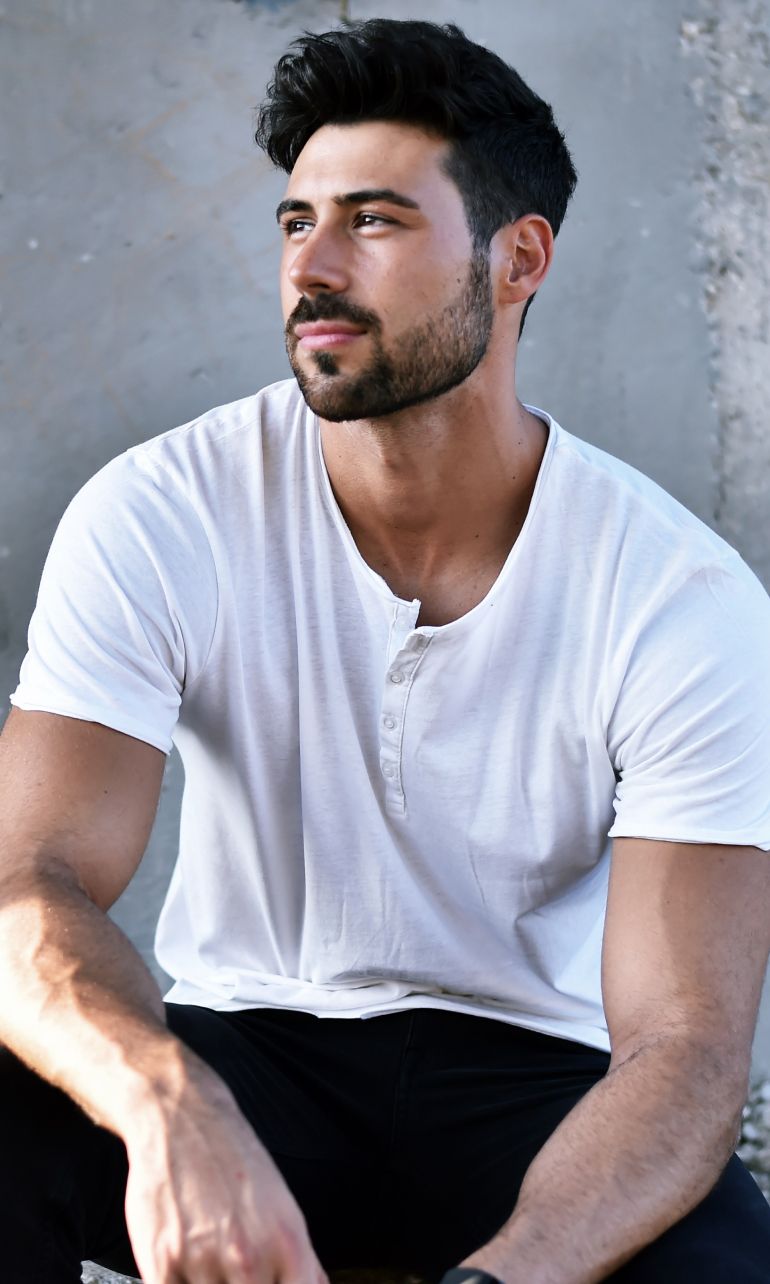 Farmington plastic surgery model sitting casually in a white shirt.