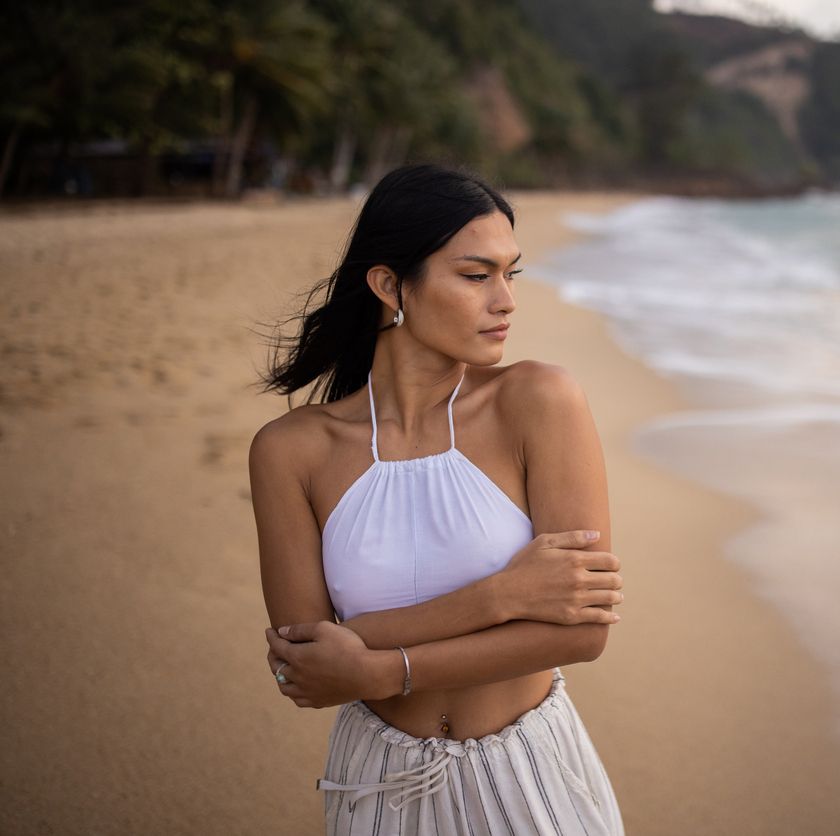 Farmington facial feminization surgery model in white top on a beach.