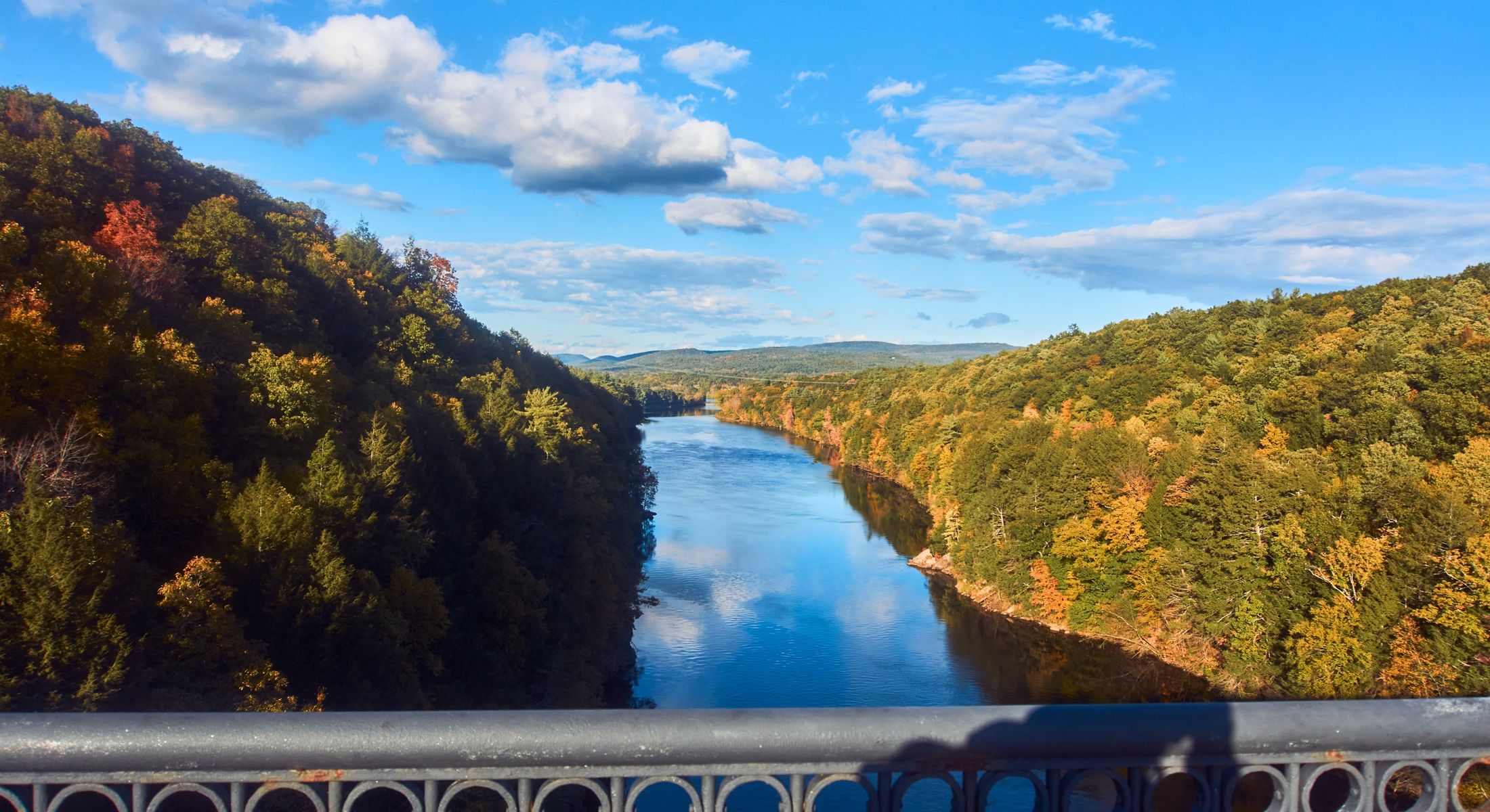 Scenic river view surrounded by autumn foliage.