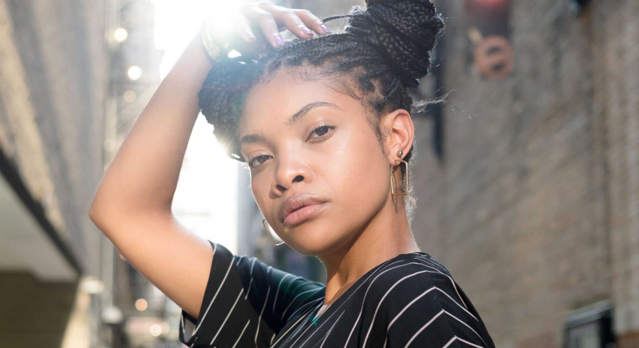 Fashionable woman posing in urban setting.