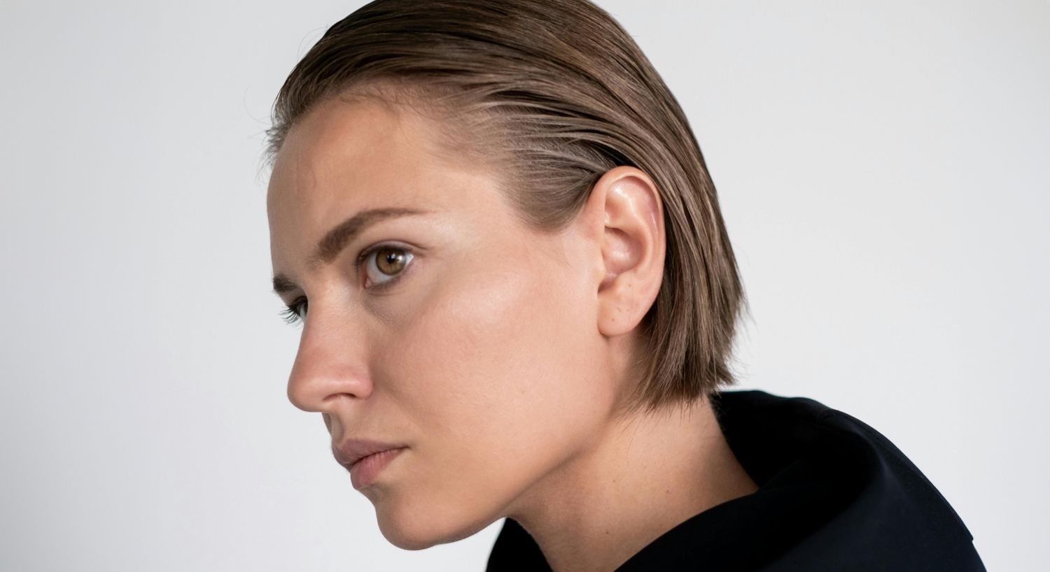 Profile of an Avon ear reshaping model with short hair.